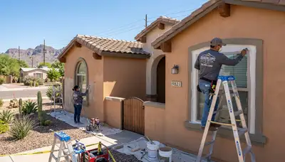 Professional house painters working on exterior home repaint in Scottsdale, AZ